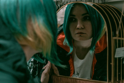 Close-up of woman looking in mirror