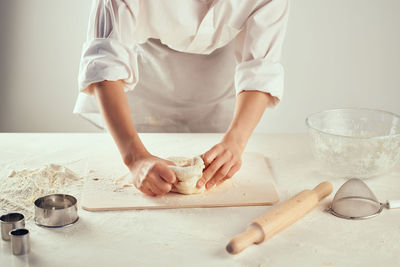 Midsection of woman preparing food on table