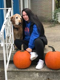 Portrait of woman with jack o lantern on pumpkin