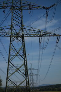 Low angle view of electricity pylon against sky