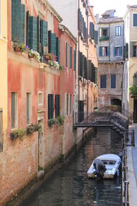 Boats in canal with buildings in background