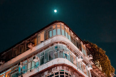 Low angle view of illuminated building against sky at night