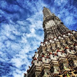 Low angle view of building against cloudy sky