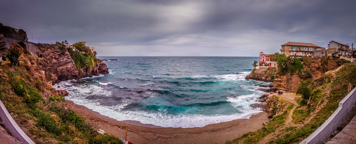 Scenic panorama view of sea against dramatic sky