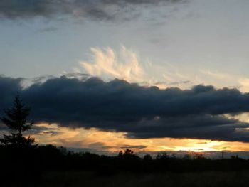 Scenic view of silhouette landscape against sky at sunset
