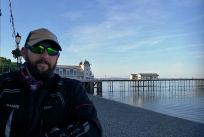 Portrait of man wearing sunglasses against sky