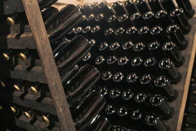 Upside bottles in a vinery room, that it's for the traditional method of sparkling wine production