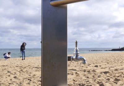 Man on beach against sky