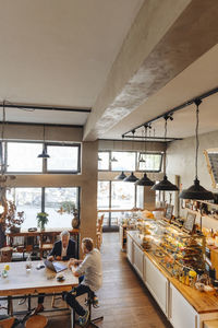 Two businessmen with laptop meeting in a cafe