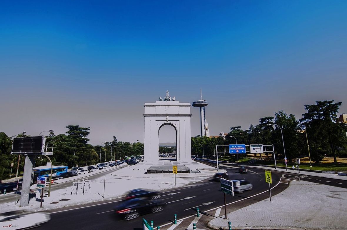 VEHICLES ON ROAD AGAINST CLEAR SKY