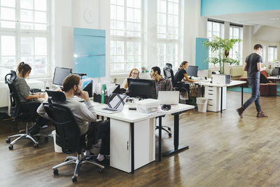 Business people working at desks in creative office