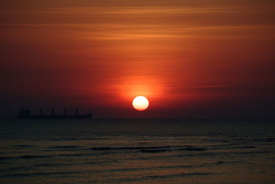 Scenic view of sea against orange sky