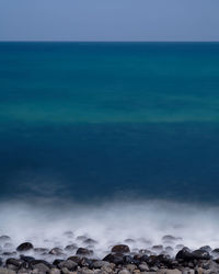 Scenic view of sea against blue sky