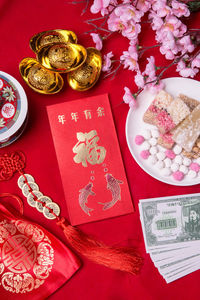 High angle view of red and flower on table