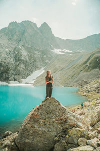 Woman standing on rock looking at mountains