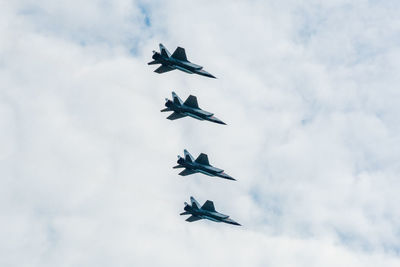 Low angle view of airplane flying against sky