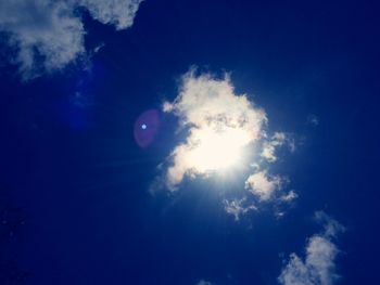 Low angle view of moon in blue sky