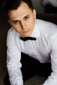 Portrait of young man sitting outdoors