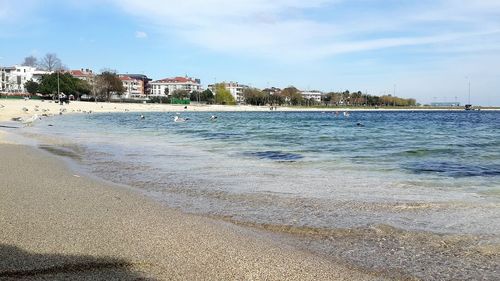 Scenic view of beach against sky in city