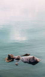 Girl lies peacefully in the blue water