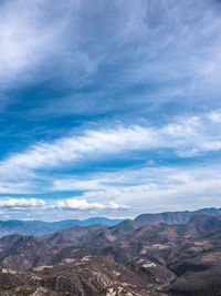 Scenic view of mountains against cloudy sky