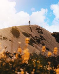 Low angle view of people on land against sky