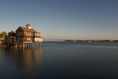 Scenic view of sea and buildings against clear sky
