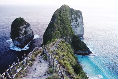 High angle view of rock formation in sea against sky