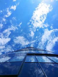 Low angle view of building against cloudy sky