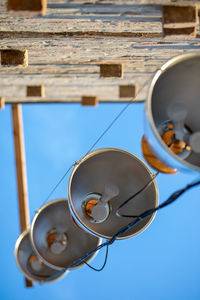 Low angle view of lamp against blue sky