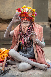 Midsection of man sitting in temple