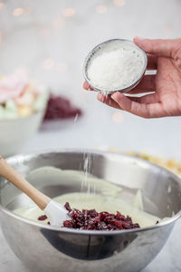 Cropped hand putting in batter