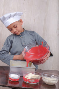 Boy preparing food on table at home