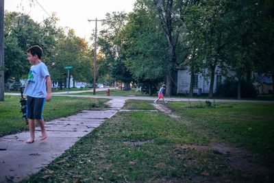 Woman walking on footpath in park