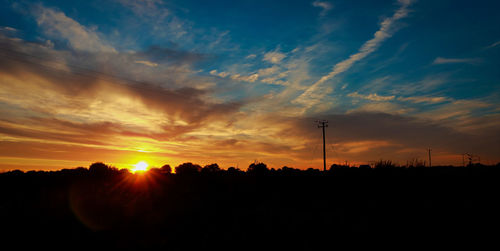 Silhouette landscape against scenic sky