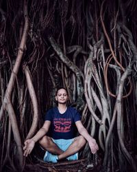 Portrait of woman standing amidst plants