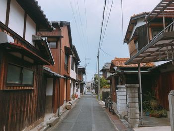 Street amidst buildings against sky