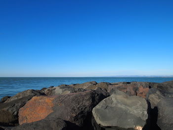 Scenic view of sea against clear blue sky