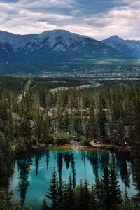 Scenic view of lake by mountains against sky