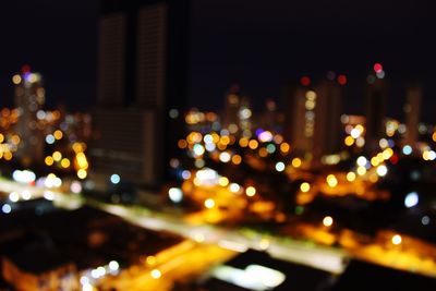 Defocused image of illuminated city at night