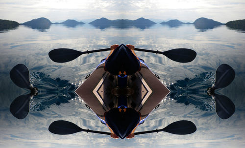 Reflection of person on umbrella in water