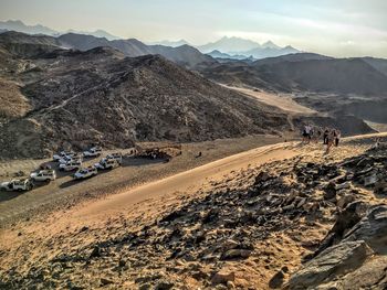 Mid distance view of people hiking on mountains