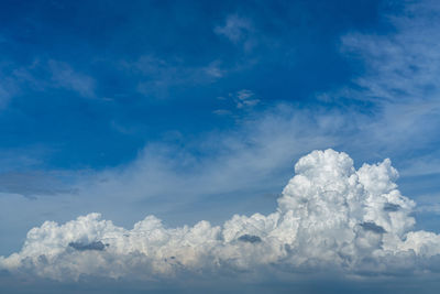 Vast white cumulus clouds with blue sky background