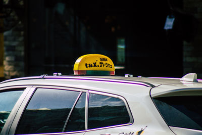 Close-up of yellow sign on car