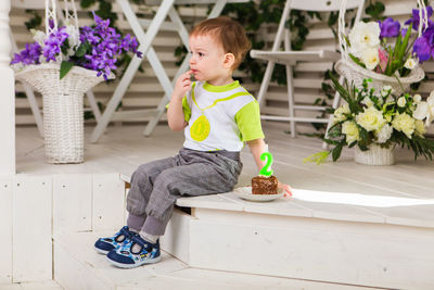 Full length of cute boy sitting on floor