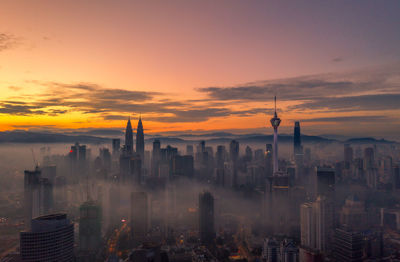 Cityscape against sky during sunset