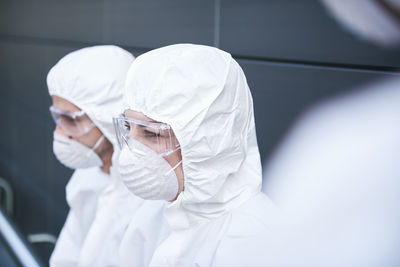 Rear view of man working with arms raised