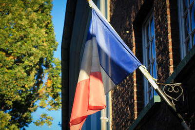 Low angle view of flags hanging on building