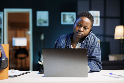 Young man using laptop at office