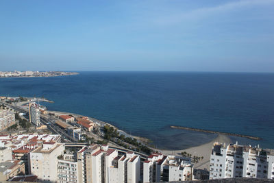 High angle view of houses against calm blue sea